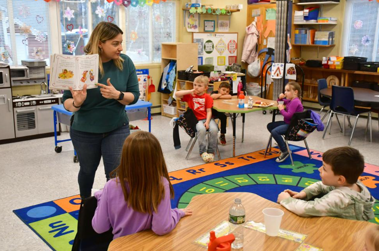 Pre-K and kindergarten teacher Christina Engwer reads a story to her class at Savoy Elementary School