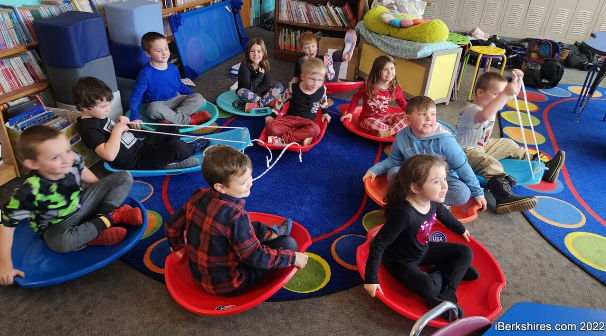 Youngsters at Gabriel Abbott Memorial School try out their new saucer sleds on Thursday